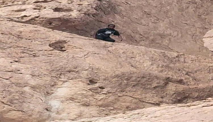 بالصور والفيديو.. إنقاذ مهاجر إفريقي عالق في جبل مطل على عتق.. ومصرع أحد رفاقه